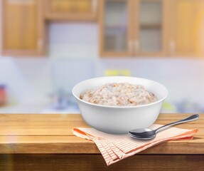 Tasty breakfast Oatmeal porridge in white bowl
