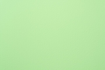 Painted wall of light green color. Textured background.