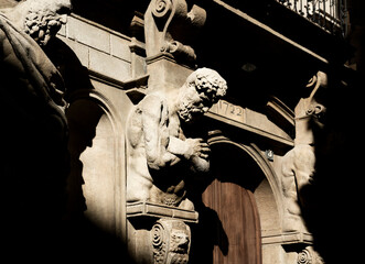 Detail in the dim light of an atlas in the façade of the Casa degli Omenoni, historic palace...