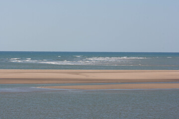 sunny beach day with white dunes and blue sea in huelva spain