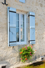 Fototapeta na wymiar French window with shutters and flowers