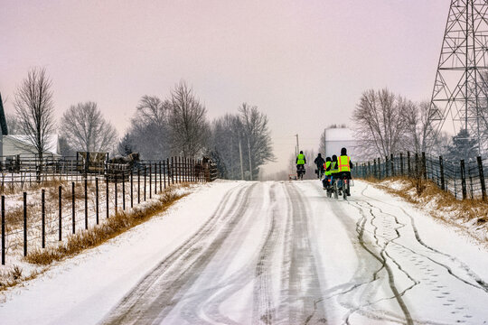 Amish Children Riding Bikes In The Snow Going To School