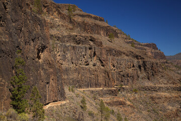 Fototapeta premium Gran Canaria, landscape of the southern part of the island along Barranco de Arguineguín steep and deep ravine with vertical rock walls, circular hiking route starting at a hamlet Barranquillo Andres 
