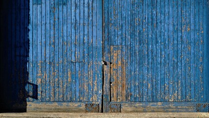 large peeling wood blue door as background