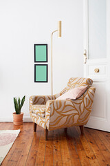 Reading corner with a single sofa, golden lamp, sansevieria pot and wooden door with glass, jute rug on varnished pine wood plank floor