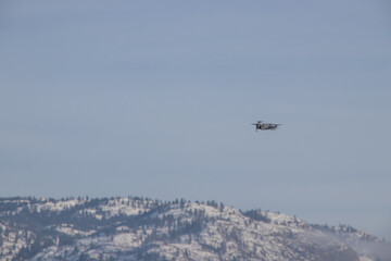 Drone flying near snow covered mountains in British Columbia, Canada
