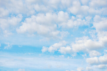 Bright blue sky with scattered white puffy clouds