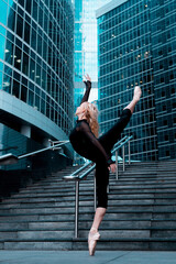 Ballet dancer in attitude pose on city street background