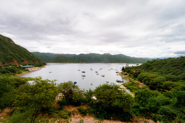 Fototapeta premium Panoramic view of the Cabra Corral reservoir with boats in Salta, Argentina