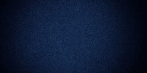 Dark blue background texture with black vignette in old vintage grunge textured border design, dark elegant teal color wall with light spotlight center
