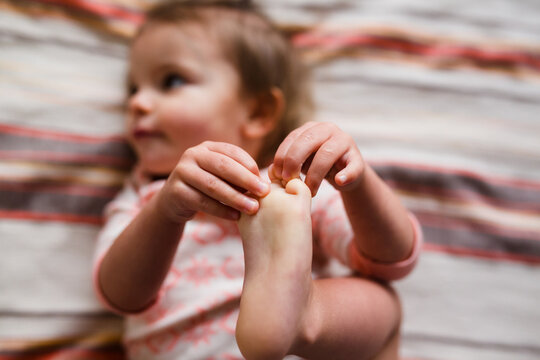 toddler grabs toes
