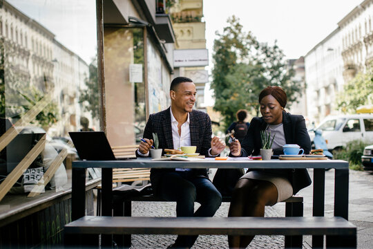 Two Work Colleagues Eating Breakfast Together