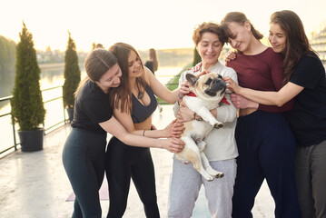 girls playing with a dog