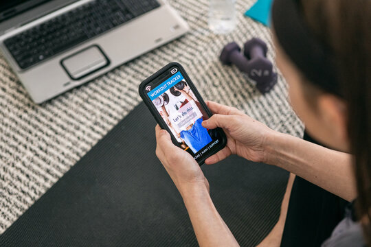 Home: Woman Ready To Use App During Virtual Exercise Class