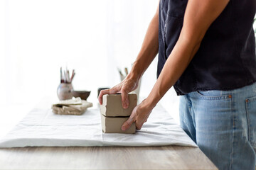 Woman Cutting Clay With String
