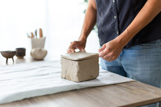 Woman Cutting Clay With String