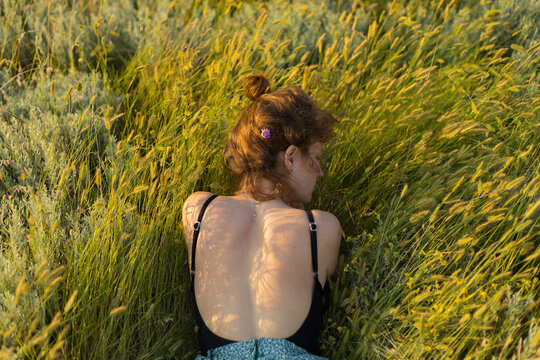 photo of a girl from the back in the field
