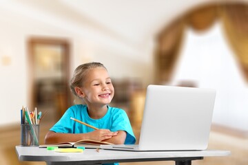 Naklejka na ściany i meble Distance education. Smiling child studying online at home,