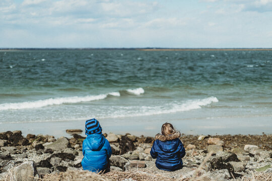 Two children sit on the rocks at Jones Beach.