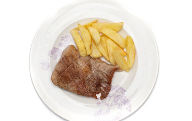 An Iberian secret, it is a highly appreciated pork meat in Spain. As a garnish some homemade chips, served on a plate. Isolated on white background.