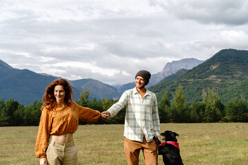 Young happy couple enjoying nature holding hands