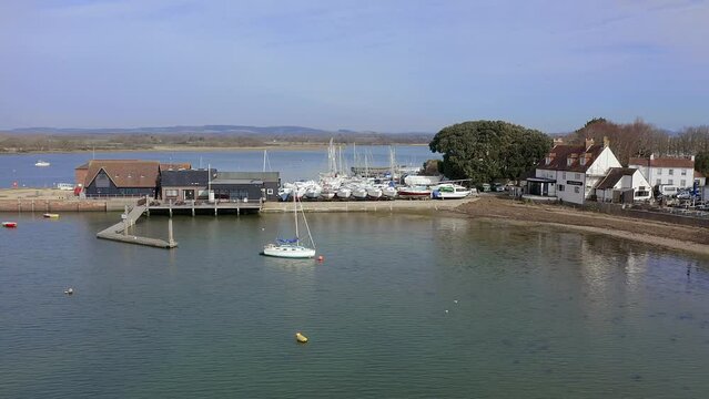 Sailing Boats and Yachts at Dell Quay in Chichester Harbour in West Sussex aerial video.
