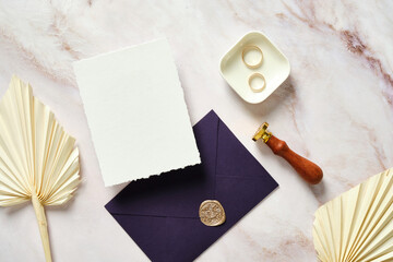 Flat lay wedding stationery on marble table. Blank wedding invitation card mockup, dried flowers,...