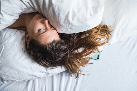 Woman in bed in the morning still asleep