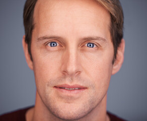 Keep it real. Closeup studio portrait of a handsome man with blue eyes.