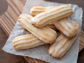 Viennese shortbreads on a wooden board. Italian buttery shortbread cookies with glazed tops