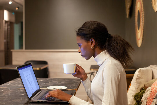 focused confident black woman working on laptop