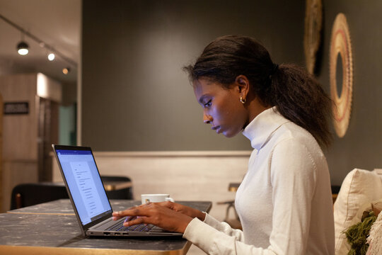 study, serious black woman student working on computer