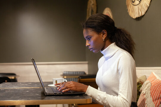 serious confident black woman working on computer