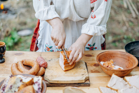 Woman in old clothes in the kitchen