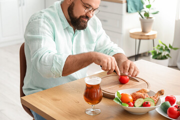 Man preparing lunch in kitchen