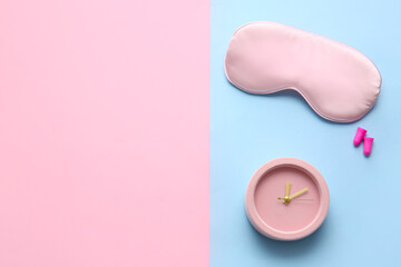 Sleep mask, earplugs and alarm clock on color background