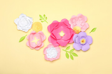 Beautiful handmade paper flowers on beige background