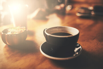 Better coffee you will not find. Shot of a cup of freshly brewed coffee on a wooden table of a restaurant.