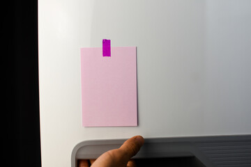 Pink note reminder paper sticked in freezer, fridge with glitter pink sticker. Refrigerator message