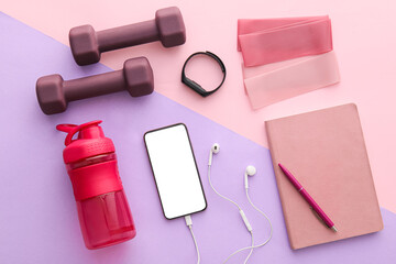 Composition with mobile phone, notebook and sports equipment on color background