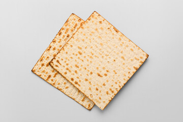 Jewish flatbread matza for Passover on light background, top view