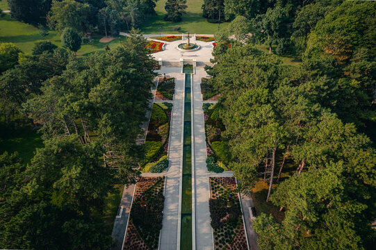 An aerial view of a picturesque fountain surrounds by colourful flower beds and lush green trees during summer time in Hamilton, Ontario, Canada.