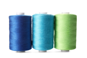 Multicolored sewing thread spools on white background