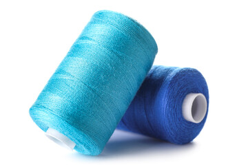 Blue sewing thread spools on white background
