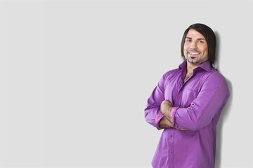 Proud and pleased man in casual wear stands with arms crossed