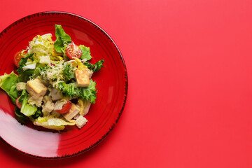 Plate with tasty vegan Caesar salad on red background - obrazy, fototapety, plakaty