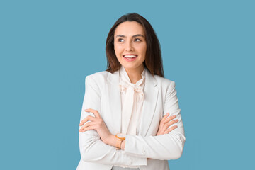 Portrait of young secretary on blue background