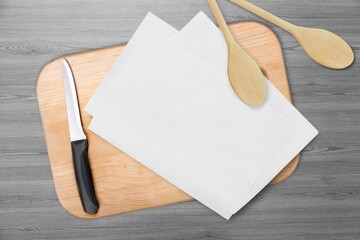 White blank cotton kitchen towel mockup, wooden spoons and cutting board.