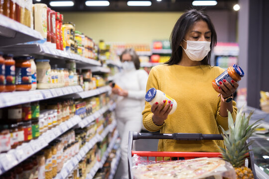 Woman In Protective Mask Shopping At Grocery Store