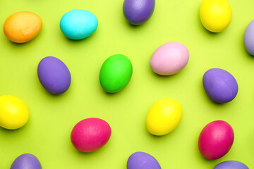 Painted Easter eggs on color background, top view